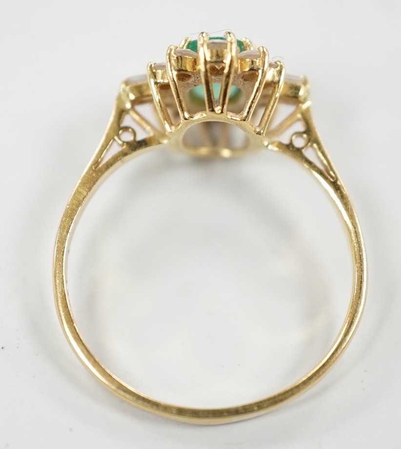 A modern 18ct gold, single stone oval cut emerald and round and baguette cut diamond cluster set ring, size P/Q, size 3 grams.